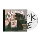 Starcrawler album cover featuring a person in a leather jacket with a Kick Me sign taped to their back, alongside the disc showing the word KICK on a lined paper tracklisting background.