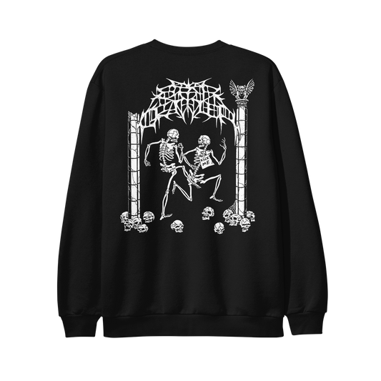 Black Independent Trading Company sweatshirt featuring a white graphic on the back of two skeletons dancing between stone pillars, with a KICK ME sign attached to one skeleton and illegible metal-style lettering above this printed hoodie design.