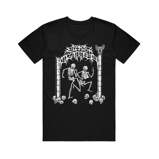 Comfort Colors black t-shirt featuring a white graphic of two skeletons dancing under a gothic arch, with one skeleton wearing a sign that reads KICK ME.