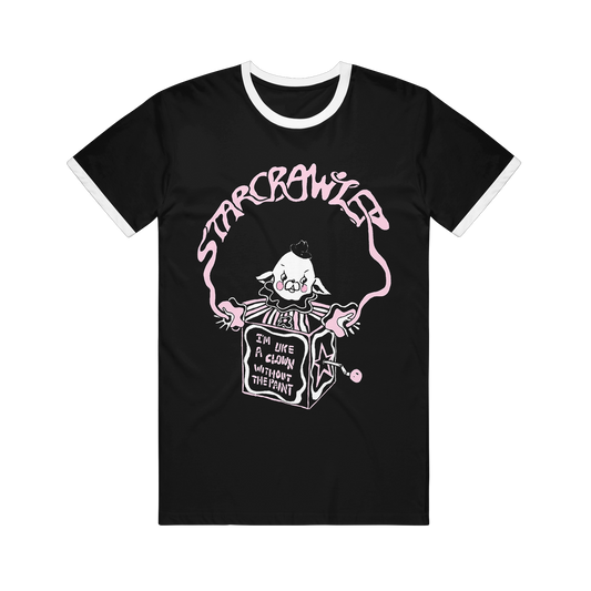 Black Tultex ringer t-shirt featuring a pink and white printed graphic of a clown popping out of a jack-in-the-box, with the text Starcrawler and I’m like a clown without the paint.